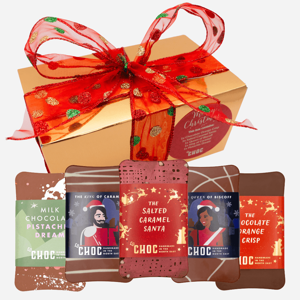 Gold Christmas chocolate gift box from La Chocolatrice with red ribbon decorated with green and gold glitter dots, and five chocolate bars.