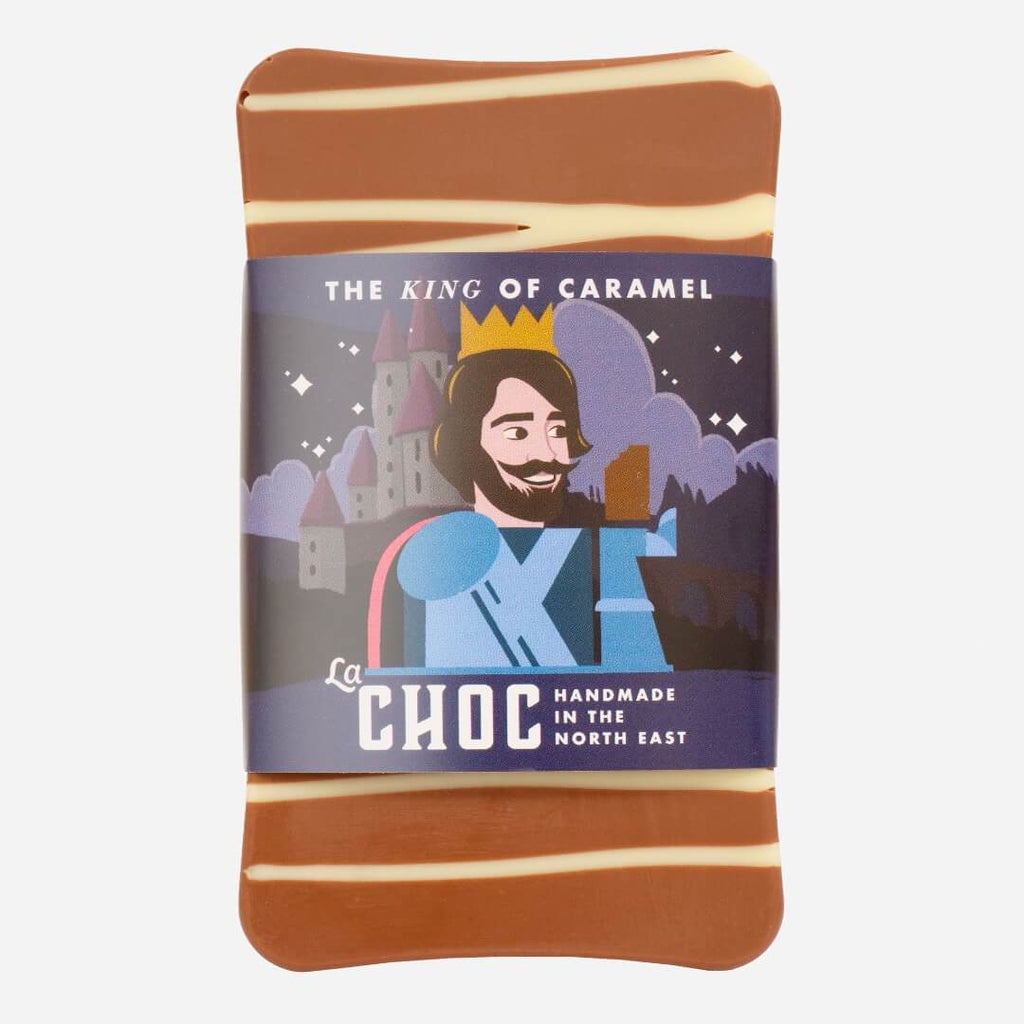 The King of Caramel milk chocolate bar by La Chocolatrice, featuring a royal-themed wrapper with a king illustration, topped with white chocolate stripes. Handmade in the North East.
