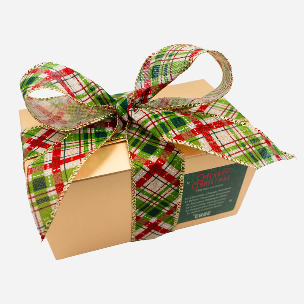 Gold Christmas chocolate gift box from La Chocolatrice with green, red, and gold tartan ribbon.
