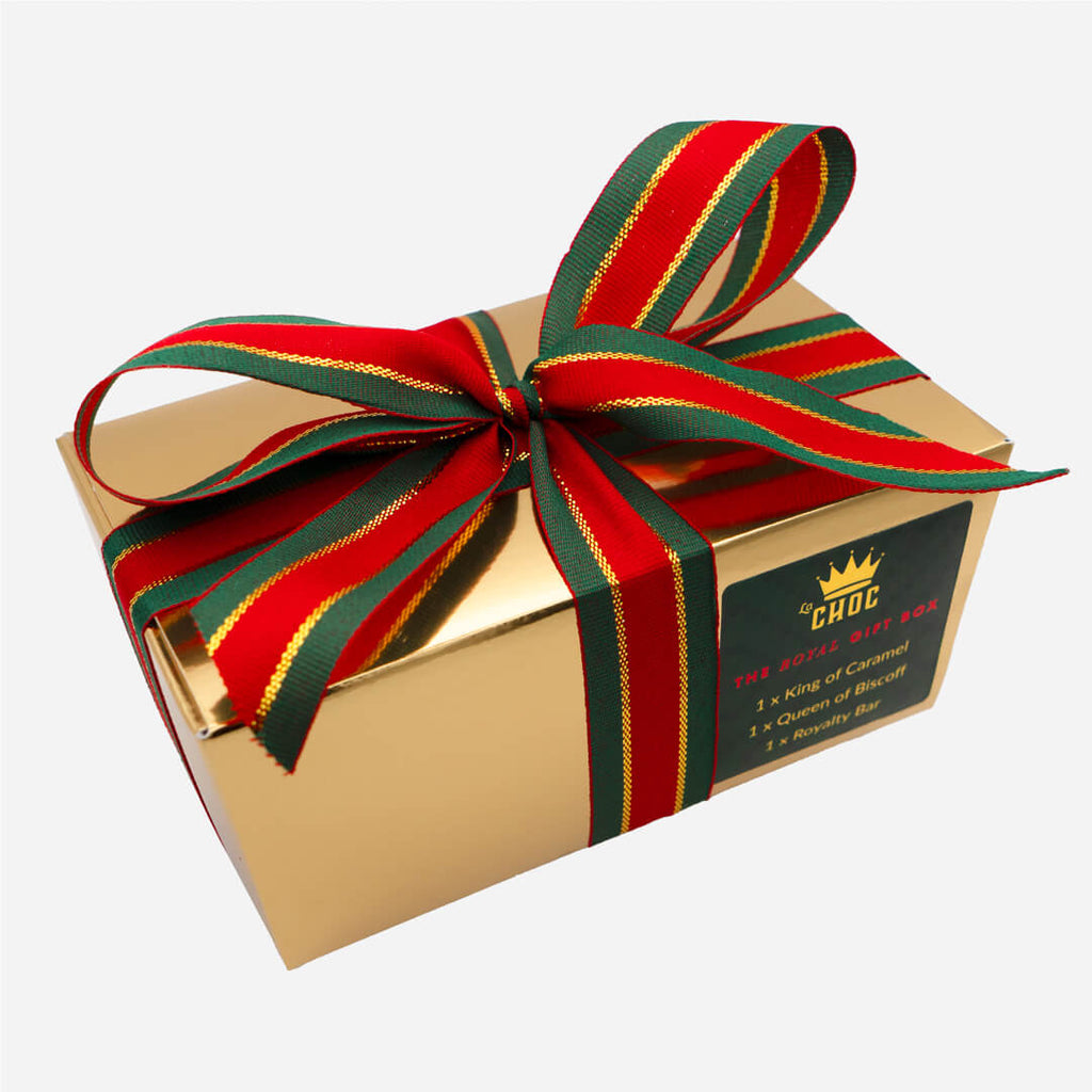 Luxury gold Royal chocolate gift box from La Chocolatrice, tied with red and green striped ribbon.